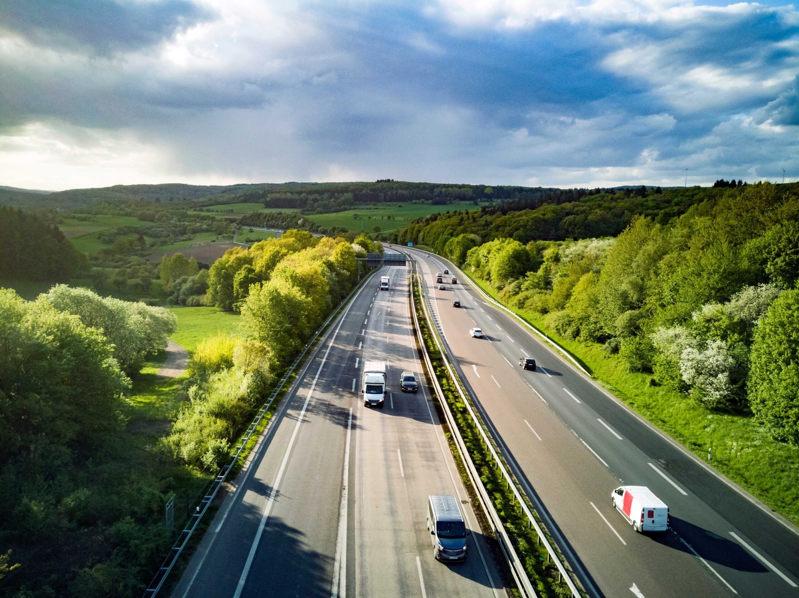Birds eye view of motorway in Germany with greenery either side demonstrating importance of car rental excess insurance.