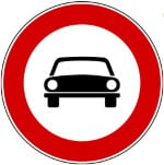 White circular Italian road sign with red border and picture of a car in the middle.